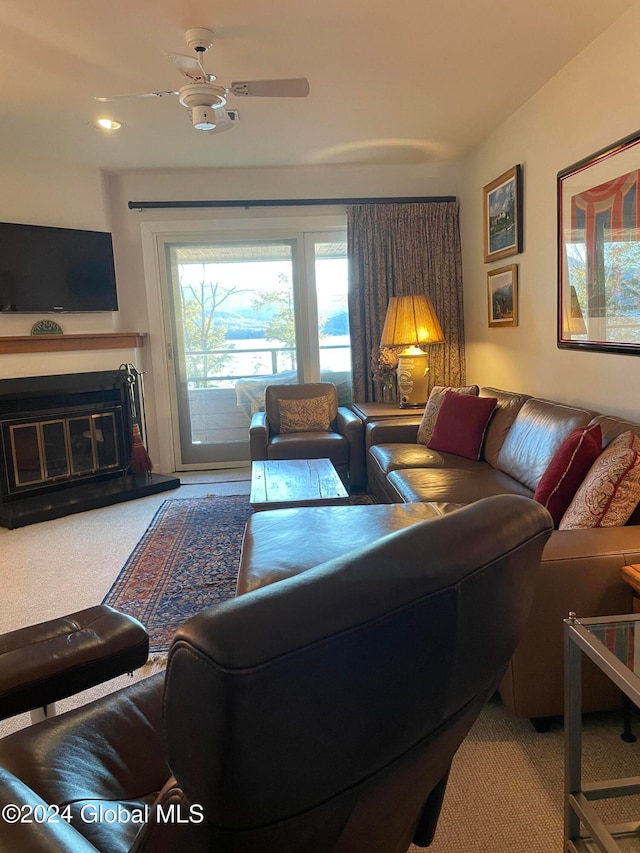 carpeted living room with ceiling fan