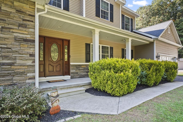 view of exterior entry with covered porch