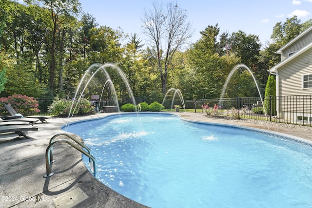 view of swimming pool with pool water feature and sink