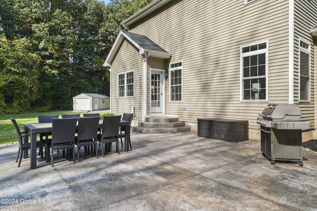 view of patio / terrace with grilling area and a storage unit