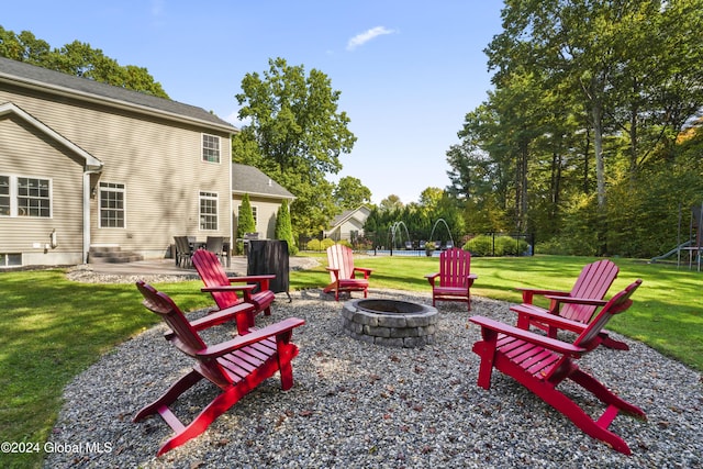 exterior space featuring a trampoline and a fire pit