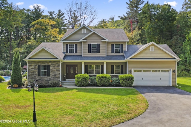 view of front of house with a garage and a front lawn