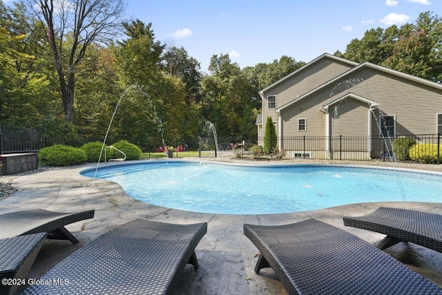 view of swimming pool with a patio and pool water feature