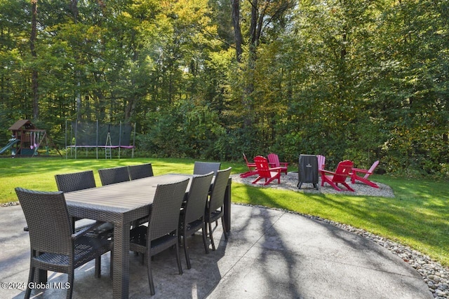 view of patio featuring a playground and a trampoline