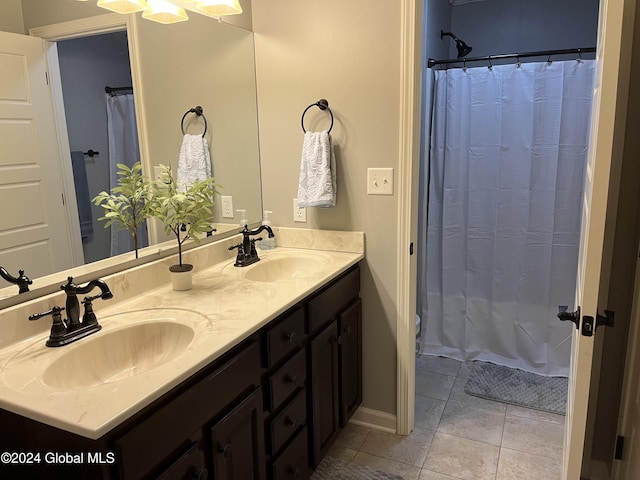 bathroom with tile patterned flooring, vanity, and a shower with curtain