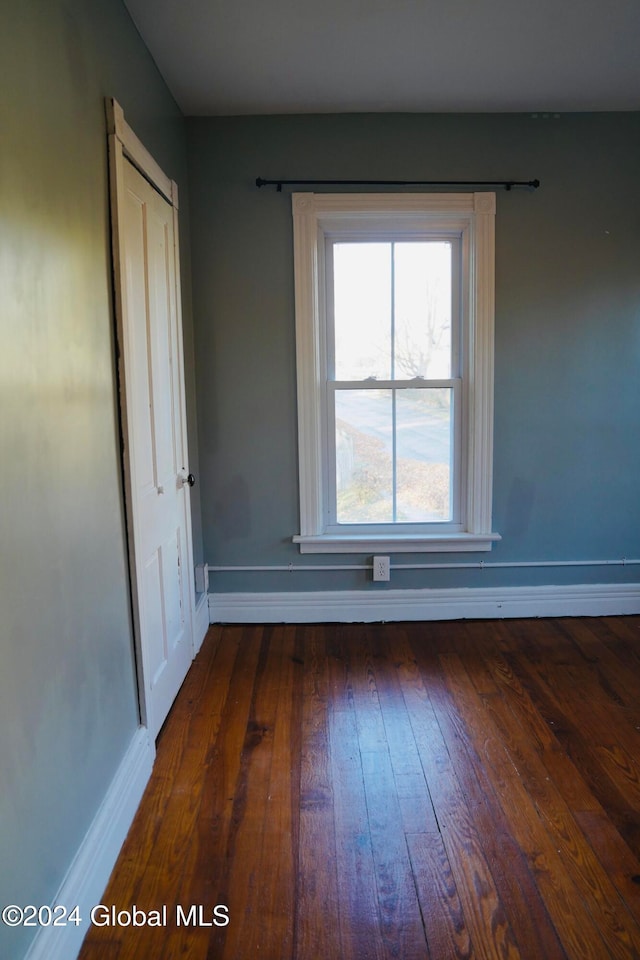 spare room featuring dark wood-type flooring