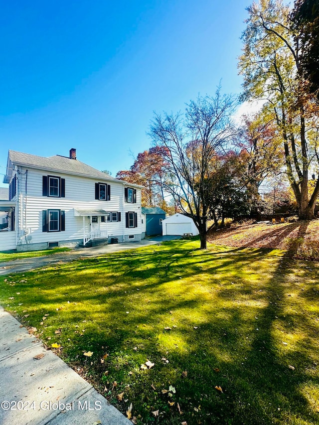 view of front of house featuring a garage and a front lawn