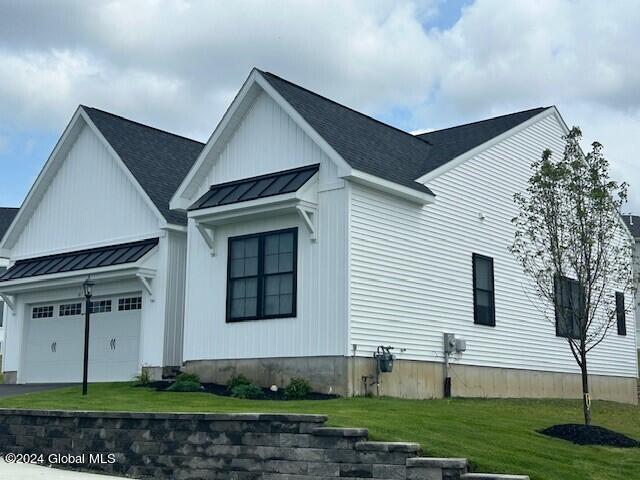 view of side of home featuring a lawn