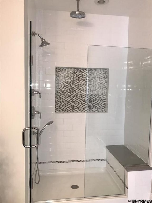 bathroom featuring a shower with shower door