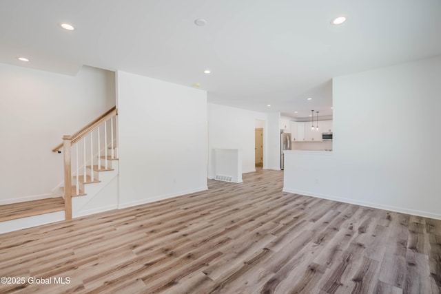 unfurnished living room featuring light wood-type flooring