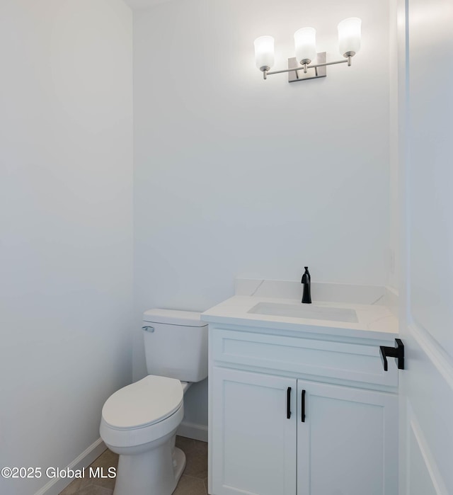 bathroom featuring tile patterned floors, vanity, and toilet