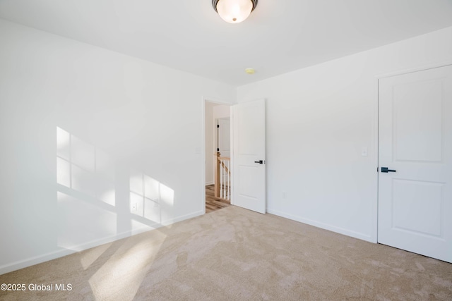 spare room featuring light colored carpet