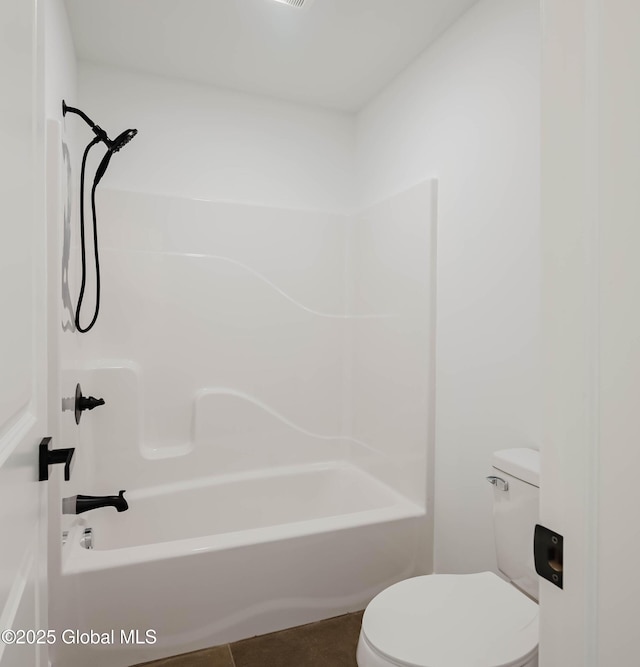 bathroom featuring tile patterned floors, toilet, and shower / washtub combination