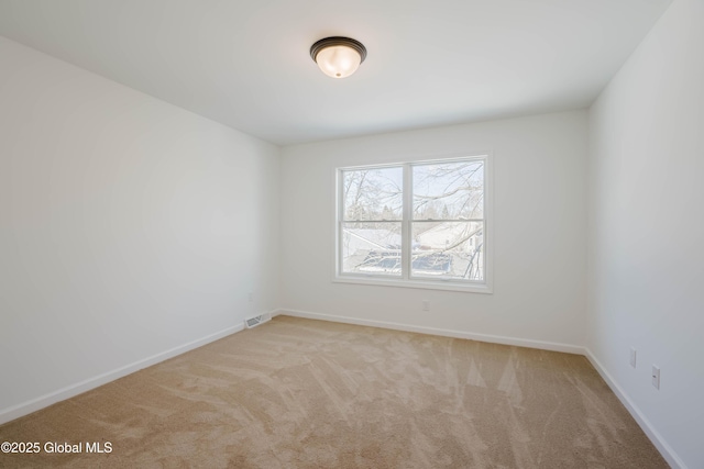 unfurnished room with light carpet