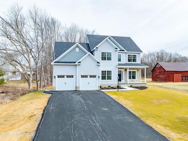 view of front of home with aphalt driveway, roof with shingles, a porch, and a front yard