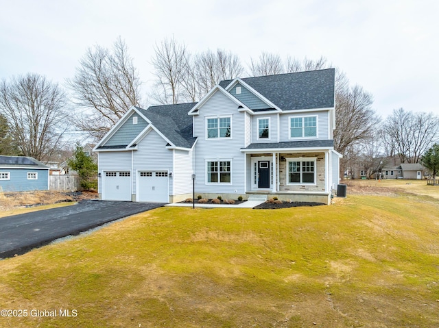 traditional home featuring fence, a front yard, cooling unit, a garage, and driveway