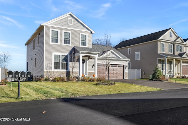 view of front property featuring a front yard and a garage