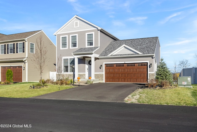 front facade with a front yard and a garage