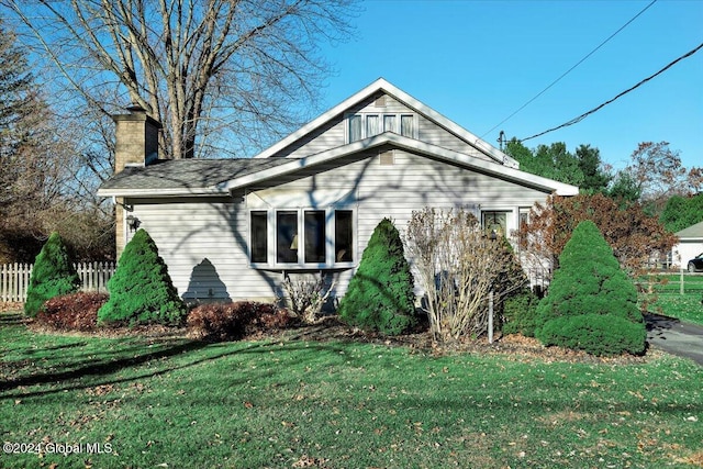 view of property exterior with a yard