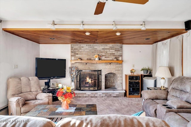 living room with carpet, ceiling fan, and a fireplace