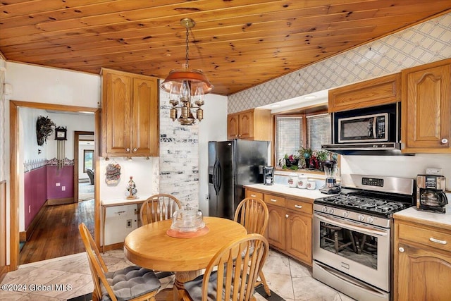 kitchen featuring wooden ceiling, black refrigerator with ice dispenser, hanging light fixtures, light wood-type flooring, and gas stove