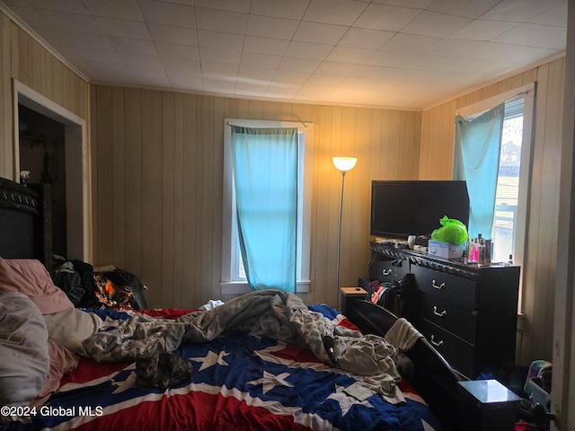 bedroom with wood walls