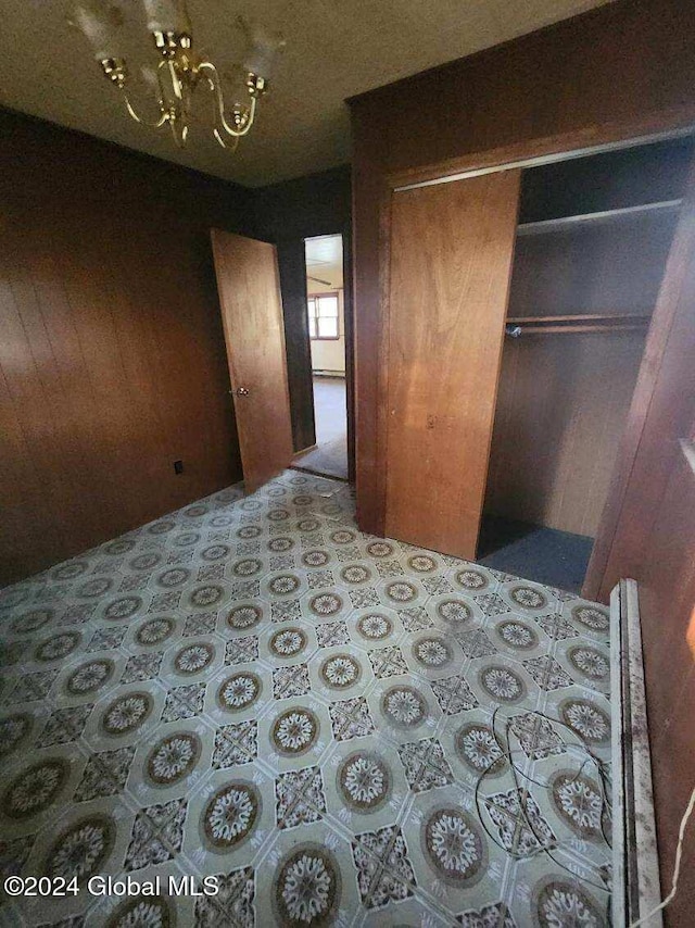 bedroom with a closet and wooden walls