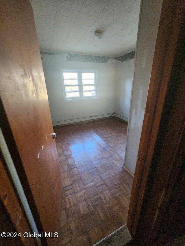 spare room featuring dark parquet floors