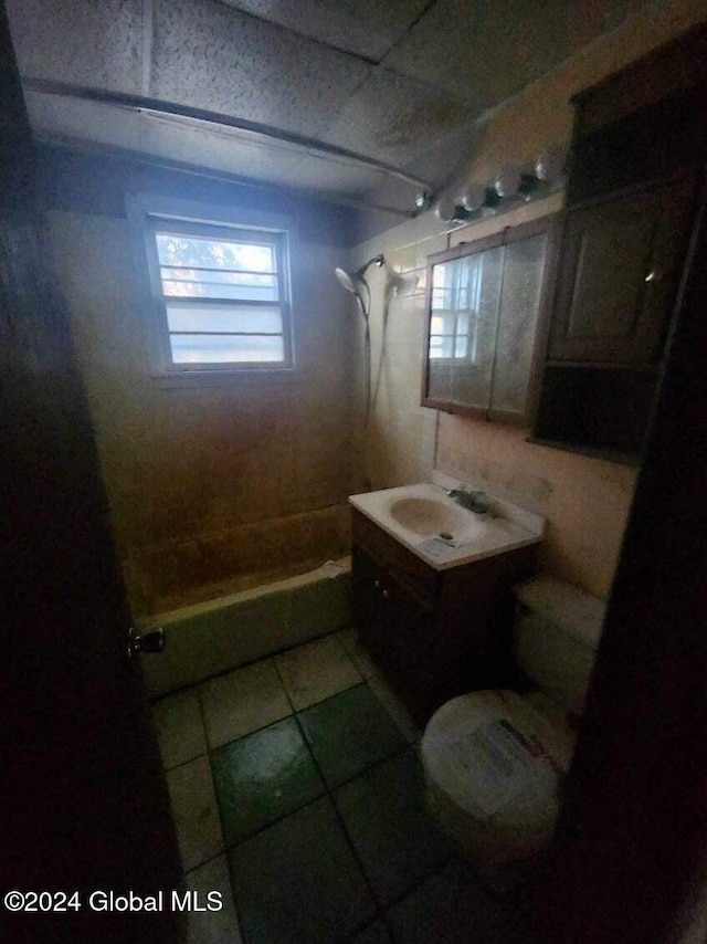 full bathroom featuring toilet, vanity, tile patterned flooring, and shower / washtub combination