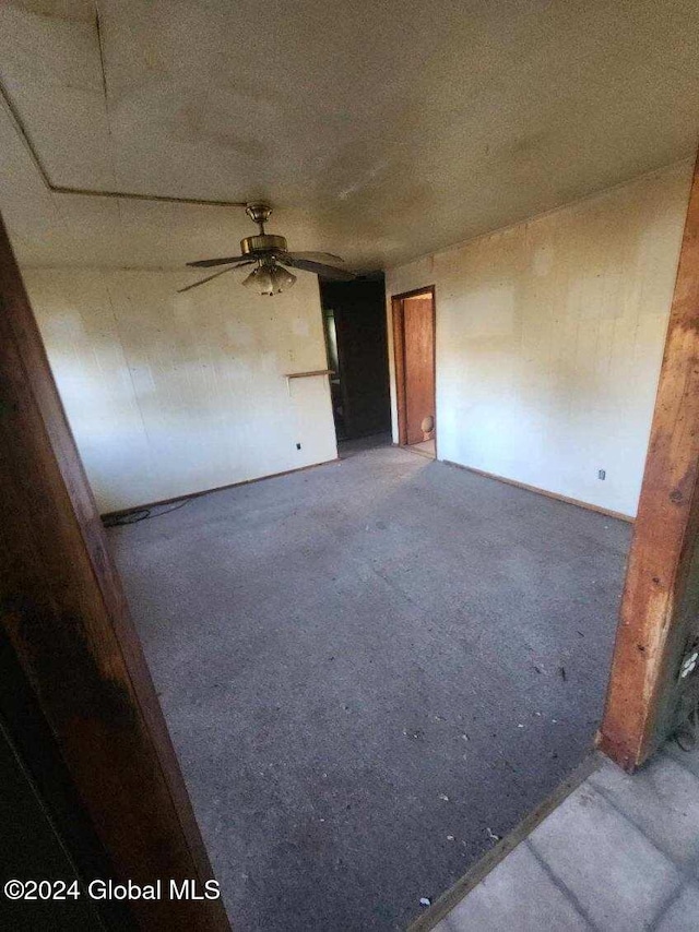 spare room featuring ceiling fan and carpet floors