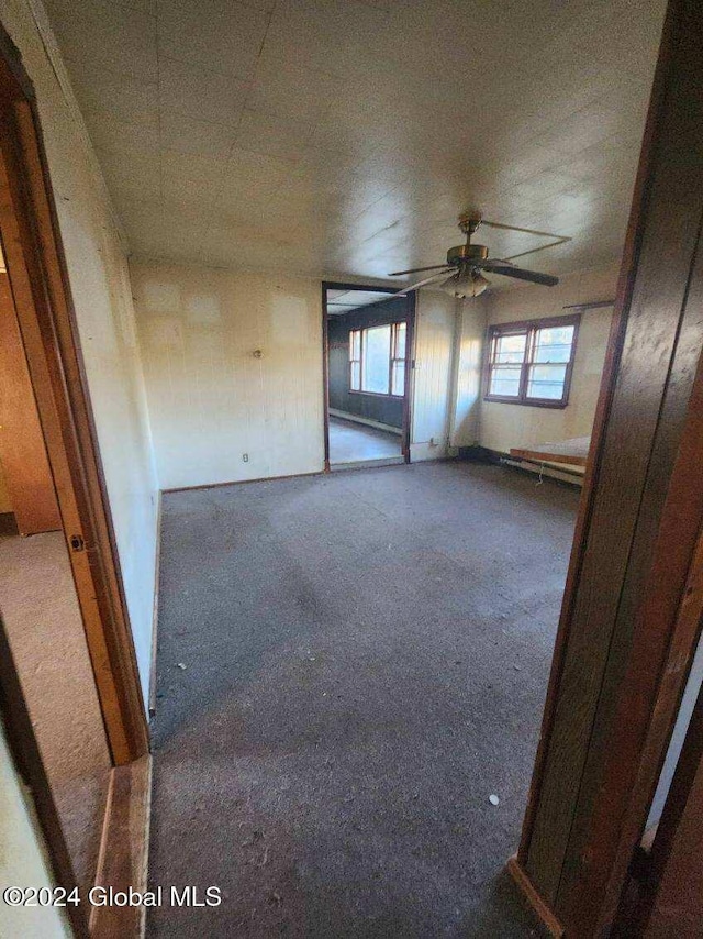 carpeted empty room with ceiling fan