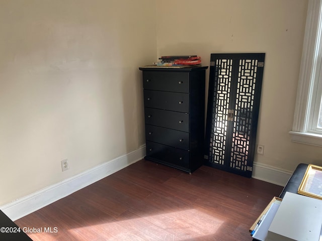 unfurnished bedroom with dark hardwood / wood-style flooring