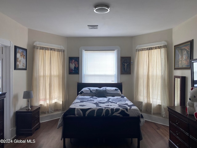 bedroom with dark wood-type flooring