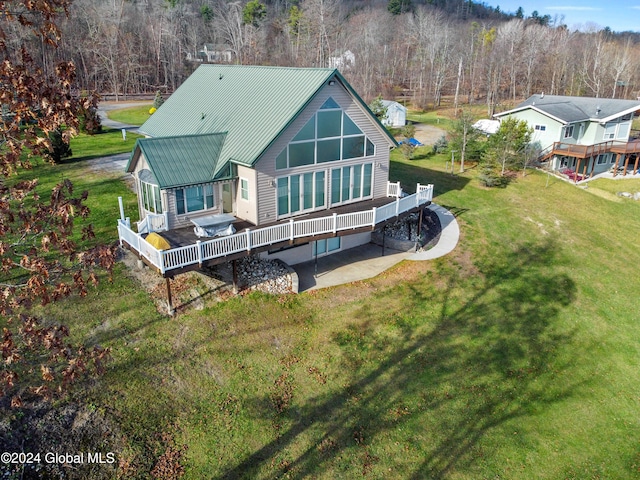 rear view of property with a patio, a yard, and a deck