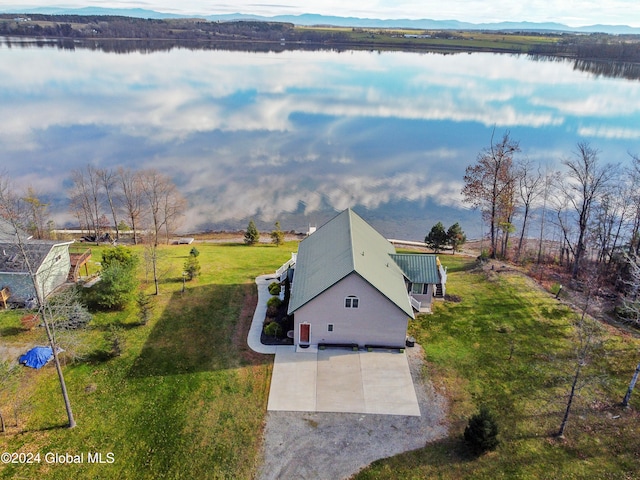 drone / aerial view featuring a water and mountain view