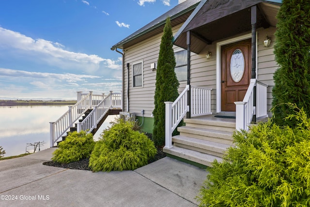 doorway to property with a water view