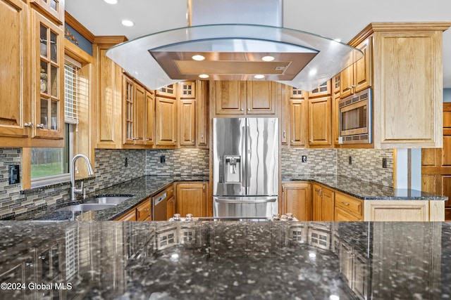 kitchen with backsplash, sink, stainless steel appliances, and dark stone counters