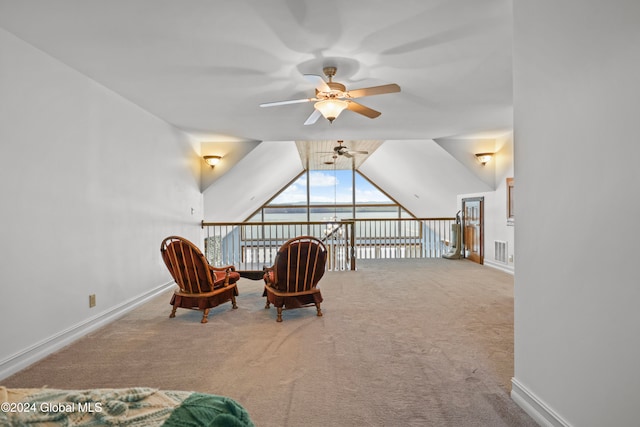 sitting room with light colored carpet, vaulted ceiling, and ceiling fan