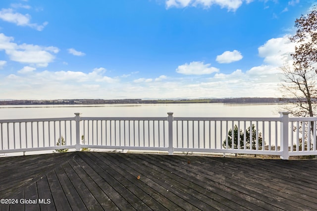 wooden terrace featuring a water view