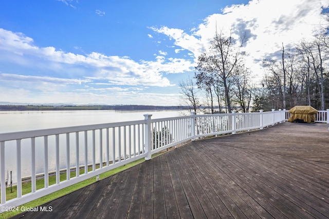 wooden terrace featuring a water view