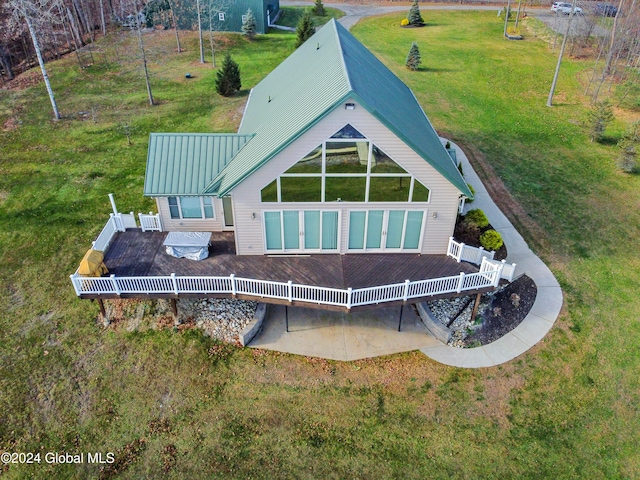 rear view of house featuring a yard and a wooden deck