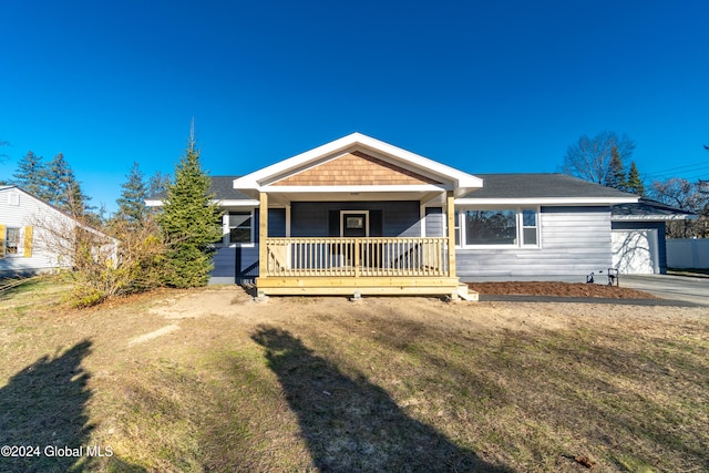 view of front facade featuring a front lawn, a porch, and a garage