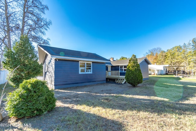 back of house with a yard