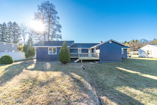 view of front of house featuring a front yard and a deck