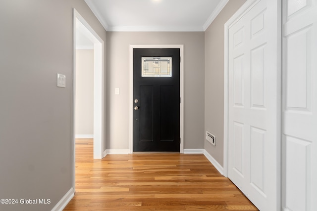 foyer entrance featuring light wood-type flooring and ornamental molding