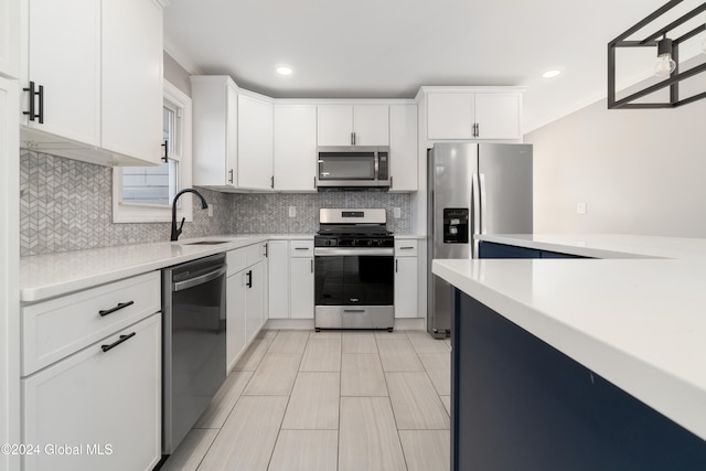 kitchen featuring white cabinetry, sink, backsplash, and stainless steel appliances