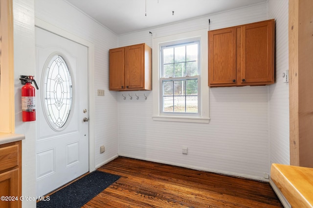 entryway with dark hardwood / wood-style flooring and ornamental molding