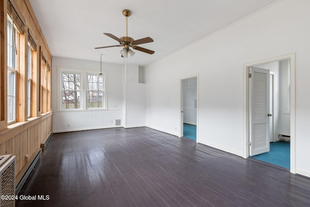 spare room with a baseboard radiator, ceiling fan, and dark hardwood / wood-style flooring