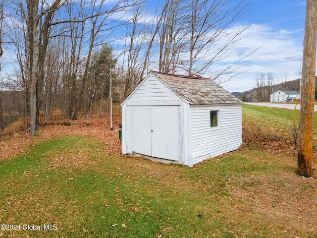 view of outbuilding with a yard