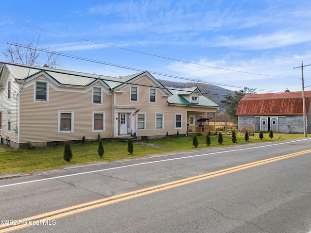 16 Main St, Worcester, NY 12064 - townhome / multi-family property featuring metal roof and a front lawn